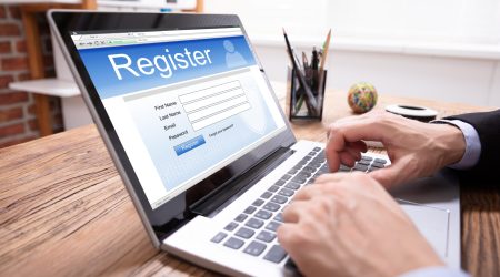 Man Filing Online Registration Form On Laptop